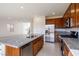 Modern kitchen with stainless appliances, granite counters, tile floor and island seating at 89 Via Franello, Henderson, NV 89011