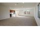 Spacious living room with carpet flooring, abundant natural light, and an open floor plan at 89 Via Franello, Henderson, NV 89011