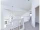 Bright upstairs landing boasts white railing, carpeted floors and a view of below at 92 Sea Holly Way, Henderson, NV 89074