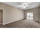 Large bedroom with ceiling fan, neutral walls, and a sliding door to a balcony with scenic views at 9303 Gilcrease Ave # 2217, Las Vegas, NV 89149