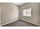 Neutral bedroom featuring carpet, base trim, window, and light-colored walls at 9303 Gilcrease Ave # 2217, Las Vegas, NV 89149
