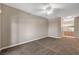 Spacious carpeted bedroom with ceiling fan and doorway to an ensuite bathroom with vanity at 9303 Gilcrease Ave # 2217, Las Vegas, NV 89149