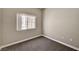 Neutral bedroom featuring carpet, base trim, window, and light-colored walls at 9303 Gilcrease Ave # 2217, Las Vegas, NV 89149