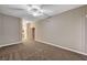 Carpeted bedroom with neutral walls, ceiling fan, and doorway to an ensuite bathroom and large closet at 9303 Gilcrease Ave # 2217, Las Vegas, NV 89149