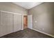 Bedroom featuring carpet, sliding door closet, base trim, and light-colored walls at 9303 Gilcrease Ave # 2217, Las Vegas, NV 89149