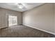 Spacious bedroom featuring plush carpeting, ceiling fan, and sliding door access to a private balcony at 9303 Gilcrease Ave # 2217, Las Vegas, NV 89149