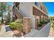 Inviting condo exterior featuring stone accents and well-maintained landscaping at 9303 Gilcrease Ave # 2217, Las Vegas, NV 89149