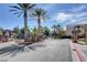 Gated community entrance with stone pillars and palm trees, providing security and curb appeal at 9303 Gilcrease Ave # 2217, Las Vegas, NV 89149