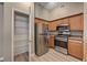 Charming kitchen with stainless steel refrigerator, oven, microwave, and wood cabinets at 9303 Gilcrease Ave # 2217, Las Vegas, NV 89149