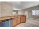 Open kitchen with stainless steel dishwasher, granite countertops, and wood cabinets at 9303 Gilcrease Ave # 2217, Las Vegas, NV 89149