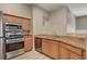 Well-lit kitchen featuring stainless steel appliances, wood cabinets, and granite countertops at 9303 Gilcrease Ave # 2217, Las Vegas, NV 89149