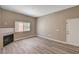 Open living area featuring a cozy fireplace and new wood-style flooring at 9303 Gilcrease Ave # 2217, Las Vegas, NV 89149