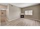 Spacious living room with a fireplace and modern wood-look floors at 9303 Gilcrease Ave # 2217, Las Vegas, NV 89149