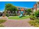 Community playground with slide and lush green turf providing a safe play area for families at 9303 Gilcrease Ave # 2217, Las Vegas, NV 89149