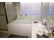 Close up of a bright bathroom with soaking tub and sink at 9440 Grenville Ave, Las Vegas, NV 89134