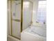 Close up of a bright bathroom with a glass-enclosed shower and soaking tub at 9440 Grenville Ave, Las Vegas, NV 89134