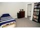 Bedroom with gray carpet, twin bed, dresser, bookcase, and white trim at 9440 Grenville Ave, Las Vegas, NV 89134