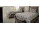 This cozy bedroom features two beds with matching floral comforters at 9440 Grenville Ave, Las Vegas, NV 89134