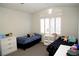 Bright bedroom featuring two twin beds, white shuttered windows, and white dressers at 9440 Grenville Ave, Las Vegas, NV 89134