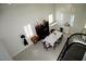 Aerial view of the dining room with white tile flooring and a table that seats eight at 9440 Grenville Ave, Las Vegas, NV 89134