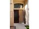 Close-up of the home's front door with an ornate security gate and adjacent window at 9440 Grenville Ave, Las Vegas, NV 89134