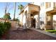 Inviting front entrance with patio seating and a well-manicured yard at 9440 Grenville Ave, Las Vegas, NV 89134