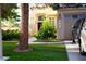 Well-manicured lawn and landscaping leading up to the front entrance of a two-story home at 9440 Grenville Ave, Las Vegas, NV 89134