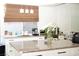 Bright kitchen features white cabinets, granite countertops, stainless steel appliances, and a large kitchen island at 9440 Grenville Ave, Las Vegas, NV 89134