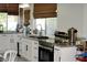 Bright kitchen features white cabinets, granite countertops, stainless steel appliances, and lots of natural light at 9440 Grenville Ave, Las Vegas, NV 89134