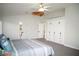 Spacious main bedroom with gray carpet, modern ceiling fan, and built-in wardrobe cabinets at 9440 Grenville Ave, Las Vegas, NV 89134