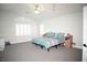 Bright main bedroom with large windows, gray carpet, and neutral walls at 9440 Grenville Ave, Las Vegas, NV 89134