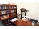 Office featuring a dark wood desk, black office chair, and dark wood bookshelf at 9440 Grenville Ave, Las Vegas, NV 89134