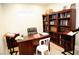 Office featuring a dark wood desk, black office chair, and two dark wood bookshelves at 9440 Grenville Ave, Las Vegas, NV 89134