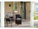 Outdoor patio featuring a table, chairs, and outdoor light fixture at 9440 Grenville Ave, Las Vegas, NV 89134