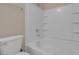 Clean white bathroom with a shower-tub combo and white tile surround at 9975 Sand Key St, Las Vegas, NV 89178