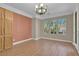 Bedroom with wood floors, three windows, and built-in cabinets with a traditional chandelier at 9975 Sand Key St, Las Vegas, NV 89178