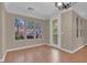 Bedroom with wood floors, four windows, and a glass balcony door at 9975 Sand Key St, Las Vegas, NV 89178