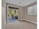 Bedroom with neutral carpet, a window with blinds, and sliding glass doors to the backyard at 9975 Sand Key St, Las Vegas, NV 89178