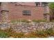 Stone monument sign for Beacon Hill, featuring a variety of plants and bushes at 9975 Sand Key St, Las Vegas, NV 89178