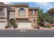 Charming townhome with a two-car garage and landscaped front, offering curb appeal and convenience at 9975 Sand Key St, Las Vegas, NV 89178