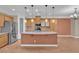 Spacious kitchen with stainless steel appliances, a center island, wooden cabinets, and granite countertops at 9975 Sand Key St, Las Vegas, NV 89178