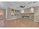 Bright living room featuring a modern fireplace and large windows with a view at 9975 Sand Key St, Las Vegas, NV 89178