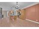 Spacious living room with wood floors and seamlessly connected to the kitchen with stainless steel appliances at 9975 Sand Key St, Las Vegas, NV 89178
