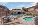 Beautiful community pool area with tables, seating, spa, and a well-maintained deck at 9975 Sand Key St, Las Vegas, NV 89178