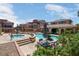 A relaxing community pool and hot tub with shade and comfortable lounge chairs at 9975 Sand Key St, Las Vegas, NV 89178