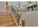 Elegant staircase featuring wood steps and wrought iron railings, adding a touch of sophistication at 9975 Sand Key St, Las Vegas, NV 89178