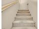 Carpeted staircase with wooden handrail providing seamless transition between floors at 9975 Sand Key St, Las Vegas, NV 89178