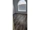 Bedroom with wood-look flooring features a arched window at 10337 Adams Chase St, Las Vegas, NV 89183