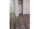 This bedroom includes wood-look flooring and closet with sliding doors at 10337 Adams Chase St, Las Vegas, NV 89183