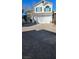 Charming two-story home with a well-maintained front yard and brick paved driveway at 10337 Adams Chase St, Las Vegas, NV 89183